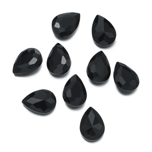 Macro view of eight faceted black pear-shaped glass rhinestones for DIY sewing