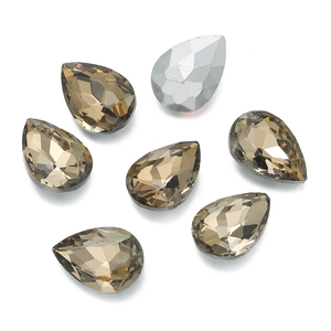 Macro shot of smoky teardrop crystal rhinestones with silver backing for DIY craft design