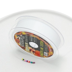 Detail of white high-strength fiber jewelry thread with 0.4mm diameter on transparent spool