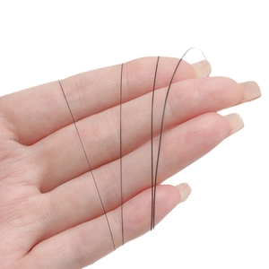 High-strength black synthetic fiber jewelry wire held by hand for DIY bracelet making