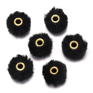 Macro detail of black faux rabbit fur balls with gold metal grommets for DIY jewelry