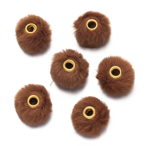 Detailed view of six brown faux fur beads with gold metal eyelets for DIY crafts