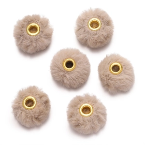 Detail of beige faux rabbit fur balls with golden metal eyelets for DIY jewelry