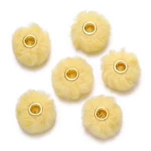 Close-up of six pale yellow faux rabbit fur beads with golden metal core for DIY crafts