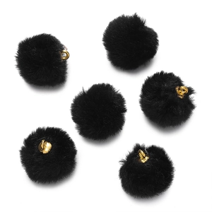 Close-up of fluffy black plush pom-pom charms with gold metal rings for DIY jewelry making