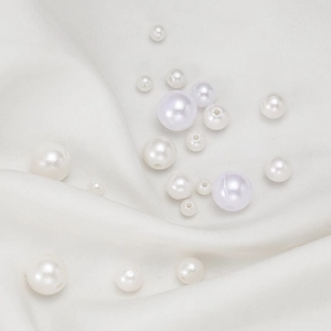 Macro shot of assorted round ABS faux pearls with pre-drilled holes for DIY jewelry