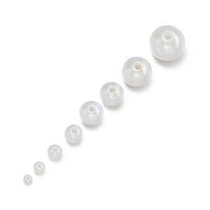 Macro shot of white ABS imitation pearls in multiple sizes with glossy finish