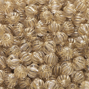 Makro-Detail von Acrylperlen mit goldenen Streifenmustern für DIY-Schmuckherstellung