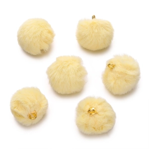 Close-up of light yellow faux mink fur pompom pendants with gold metal rings