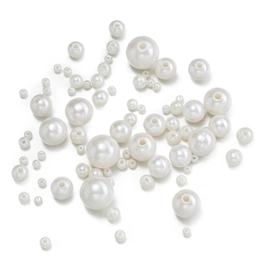 Detailed view of assorted white ABS imitation pearls with holes for DIY craft and jewelry