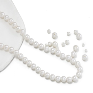 Detail of round white ABS imitation pearl beads for DIY jewelry with elegant luster