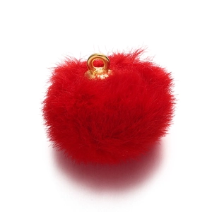 Macro shot of fluffy bright red faux mink fur pom pom with gold metal loop for DIY jewelry