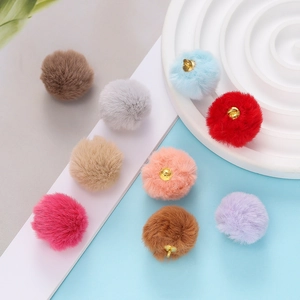 Close-up of multicolored plush faux mink fur pendants with gold metal rings for DIY jewelry