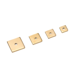 Macro view of gold stainless steel square spacer beads in four different sizes for DIY jewelry