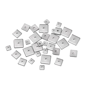 Macro view of square stainless steel spacer beads in various sizes for DIY jewelry making