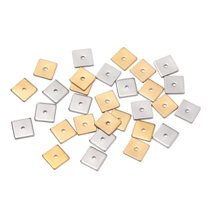 Detailed view of square matte stainless steel spacers with holes in gold and silver
