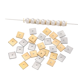 Detail of square stainless steel spacer beads in gold and silver for DIY jewelry