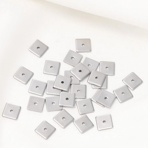 Macro detail of square stainless steel spacer beads with center holes for DIY jewelry