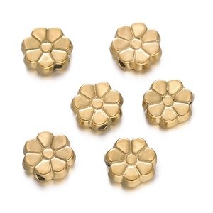 Detailed view of six golden stainless steel flower spacer beads for DIY jewelry making