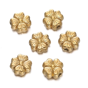 Detail of six golden five-petal flower spacer beads for DIY jewelry making