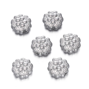 Macro view of six silver stainless steel floral spacer beads for jewelry DIY making