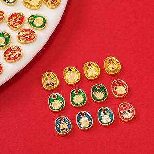 Macro view of alloy gold-plated zodiac pendants with colorful enamel lucky characters