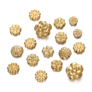 Detailed macro view of golden stainless steel flower beads and textured DIY jewelry spacers