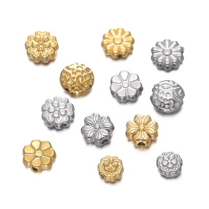 Macro shot of gold and silver flower spacer beads with holes for DIY jewelry making