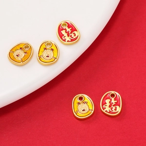 Detail of gold enamel zodiac charms with Fu character and cute pig designs