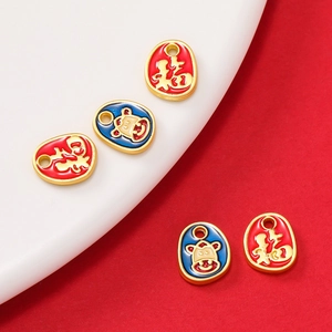 Detail of red and blue enamel Fu character pendants with cartoon animal designs