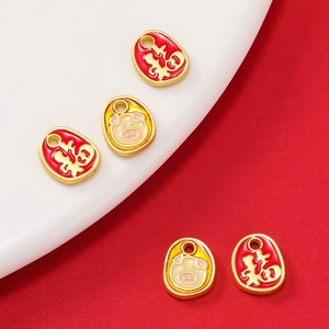 Macro shot of gold-plated alloy pendants with Fu character and cute pig enamel patterns