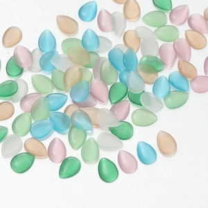 Detailed view of colorful teardrop cat eye glass cabochons for DIY jewelry making