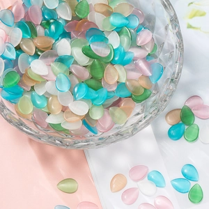 Macro detail of mixed color teardrop cat eye glass cabochons for DIY jewelry making