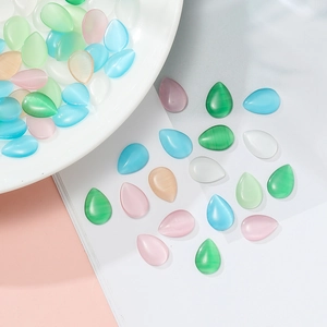Macro shot of colorful teardrop cat eye glass beads for DIY jewelry and necklace crafting