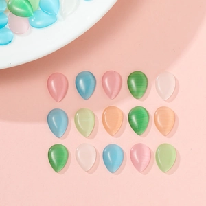 Macro detail of drop-shaped cat-eye glass beads in various colors for jewelry making