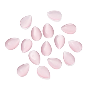 Macro view of teardrop-shaped pink cat-eye glass cabochons with smooth flat back