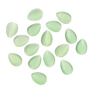 Flat lay of drop-shaped mint green cat eye glass cabochons on white background