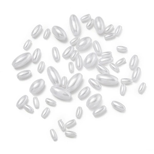 Macro detail of oval ABS imitation pearl beads with smooth cream luster for DIY jewelry