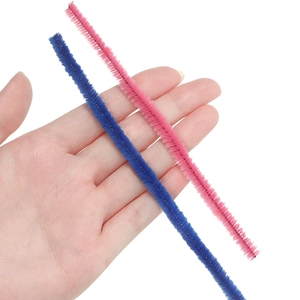 Detail showing plush texture of dark blue and pink DIY fuzzy pipe cleaners held by hand