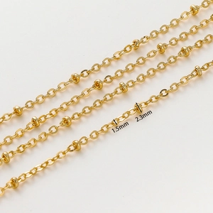 Detailed close-up of 1.5mm gold bead chain and 2.3mm spheres for DIY jewelry making