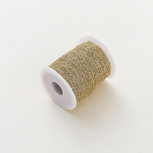 Detailed view of 1.8mm golden bead cable chain on white spool for jewelry making DIY