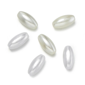 Detailed view of six oval cream ABS faux pearl beads for DIY jewelry and accessory making