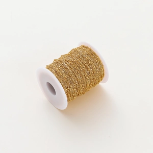 Close-up of 1.8mm gold-plated beaded chain on a white spool for DIY jewelry making