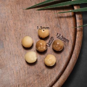 Detailed macro of hand-carved Bodhi root Buddha head beads with 1.3mm hole size