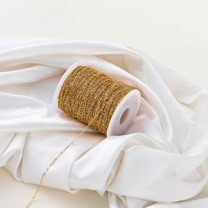Detailed view of 1.8mm gold-plated beaded O-chain roll for DIY jewelry making