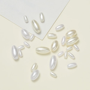Detailed view of polished cream white oval ABS imitation pearl beads for DIY jewelry making