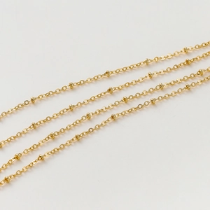Macro shot of 1.8mm golden satellite chain with small beads for DIY jewelry making