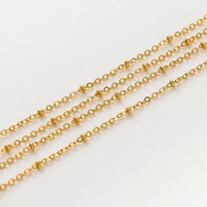 Close-up of 1.8mm gold-plated station chains with small beads for DIY jewelry crafting