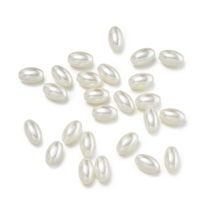 Macro detail of oval ABS imitation pearls with creamy white luster for DIY jewelry making