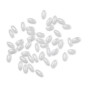 Macro view of oval ABS faux pearl beads with a glossy pearlescent finish for DIY jewelry